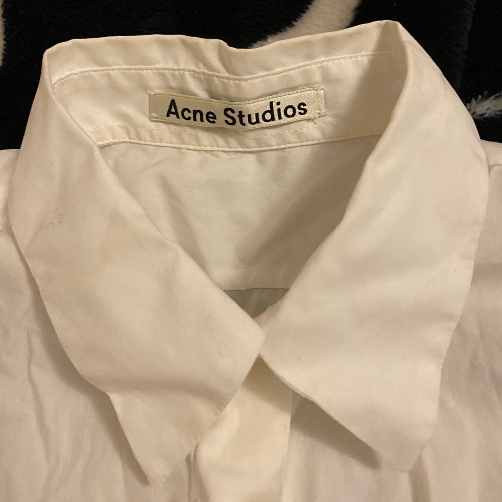Acne Studios white sleevless button down.